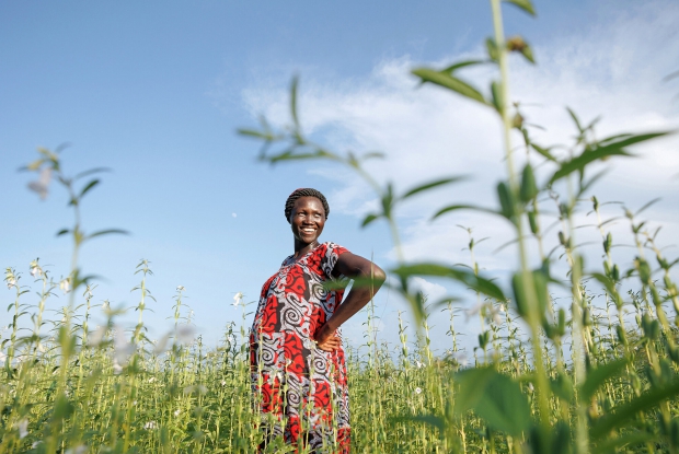 Kujang, a refugee from South Sudan stands in her vast simsim garden she owns with two other colleagues. Their group is a beneficiary of the DREAMS program which aims at enabling the poorest refugee and host community households to improve their income and well-being significantly and sustainably by providing them with the capital and skills. On assignment for Mercy Corps 2022