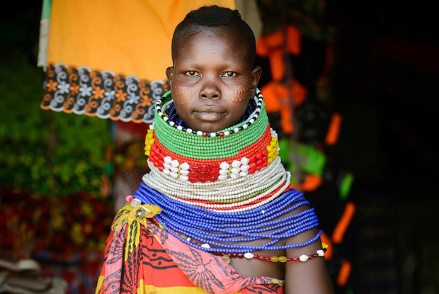 In 1992, the Turkana in Kakuma area were faced with a situation of having to live side by side with huge numbers of complete strangers.  UNHCR set up a refugee camp in Kakuma, in order to accommodate refugees from Sudan, Somalia, Ethiopia and other countries and by August 2001, the camp had more than 80,000 people. Previously, and even currently, there has been word of how old customs of tribalism are prevalent in Africa, and that people cannot overcome cultural frictions to create an orderly world spontaneously.  Looking at these beautifully endowed women co-exist with refugees during my visit to Kakuma in 2015 only proves that people can find ways of coexisting with cultural &ldquo;others.&rdquo; (2015)