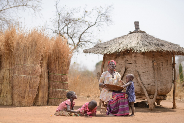 25/01/2018  Kitgum, Uganda - Ayo Narasista with three of her grandchildren at her home in Kitgum, northern Uganda.  To many of us, Kony and his Lord's Resistance Army (LRA) are another story that we hear of. For Ayo Narasista,  it&rsquo;s a story that impacted her life. Her son, who was her hope for continuing the family name was abducted by armed men on his way from school in 2002. He was 13 years old then.  Ayo's son was abducted during the 20-year conflict in northern Uganda between the Lord&rsquo;s Resistance Army and the government of Uganda. Thousands of people went missing as a result of the fighting, and the fate of many of them remains unknown today.  So isolated and depressed, I had a daughter but she also died, leaving me with 6 grandchildren to raise.&rdquo; Ayo&rsquo;s situation highlights one of the crucial roles grandmothers often play in raising grandchildren in African settings. Many times, they are primary caregivers, providing stability and offering emotional support, particularly when parents are unable to do so due to factors like poverty and death. - &copy; Jjumba Martin for The International Red Cross and Red Crescent Movement 2018