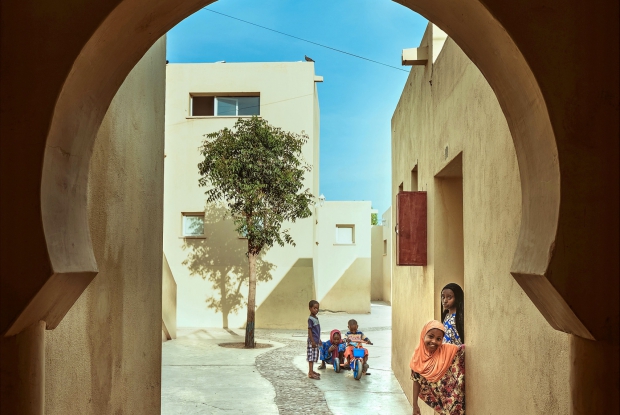 6 April 2019, Tadjoura, Djibouti. I was commissioned by the Agakhan award for Architecture to shoot a couple of projects shortlisted for the award. One of them was SOS Children&rsquo;s Village, located in Tadjourah, one of Djibouti&rsquo;s oldest towns. A compound of 15 houses for children, not far from where the hottest temperature ever was recorded, the architects designed this medina according to extreme weather conditions and community traditions. Based on the model of SOS Children&rsquo;s Villages, the project team at Urko Sanchez Architects designed 15 houses in a medina-styled complex designed to shelter at-risk children and give them the chance of a normal childhood in a loving family. Each unit, built in cement blocks and RC structure, houses six to seven children and a foster mother. The design emulates the traditional layout of narrow streets, wind towers, and lattices providing natural shade and ventilation. Because the local people were traditionally nomadic herders and lived in broad open spaces such as the desert, the sand color chosen for the walls and the openings between the different spaces echo this lifestyle. Only the bedrooms have doors. This award is given every three years to projects that set new standards of excellence in architecture, planning practices, and historic preservation, seeking to identify and encourage building concepts that successfully address the needs and aspirations of societies across the world. &copy; Jjumba Martin for AKDN 2019.