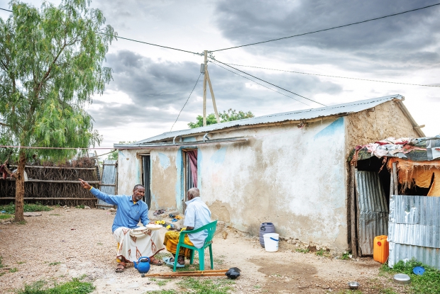 May 11th, 2024- Sheder Refugee Camp, Power lines as seen connecting to Ali Bahnan&rsquo;s home in Sheder refugee camp, northeastern Fafan Zone in the Somali region of Ethiopia. Through the Enter Energy Program, access to power is increasing people&rsquo;s opportunities for education, protection, communication, and income generation. In 2008, Ali had to flee from Somalia because of the unending Al Shabaab attacks. Choosing to stay home became a risk to his life. The best option, he said, was to cross into Ethiopia and seek aid &ldquo;and we are lucky that when we got here, UNHCR received us well and have since settled here.&rdquo; &ldquo;Right now, I'm staying with my wife and our four children.&rdquo; Ali reflects back on the unbearable period when he had just moved to the Camp. He says that life was complicated and even more unbearable when it was sunny. &ldquo;One couldn't even find a tree to protect oneself from the scorching sun but it is now a lot better. We have trees and there are more structures for shelter.&rdquo; On how he sustains himself and his family, Ali says that as a foreigner it is hard for him to get a job. &ldquo;Finding a source of income is by far the most challenging thing here. It's on and off - sometimes I get (small jobs to do) and other times there is no chance for me to make money.&rdquo; &ldquo;When it comes to the supply of electricity, we had to depend on the generator. Due to the scarcity of electricity, the usage of electric devices like mobile phones had to be reduced because charging them required us to first go to the trading center. Some organizations had given us solar panels but we failed to sustain them. The Mercy Corps' Enter Energy Project in our community is a blessing for both my family and the community. Before the introduction of the project, I was paying a lot of money to just get light for 2 hours at night. Community-wise, it was risky to move at night. There were numerous snake bite cases and security issues but we are now more secure and confident at night because the constant light source makes it easy for us to see what we couldn't see in the dark, back then. Some people have even extended their work hours into the night.