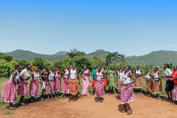 A community in Orom, Northern Uganda, performs a traditional dance by the boundaries of Kidepo National Park. Communities around protected areas like this are empowered to conserve and manage wildlife on their land, however much the human-wildlife conflict in Uganda is a growing problem that threatens the balance between conservation and the livelihoods of these communities. Several factors, including population growth, habitat loss, and competing interests cause the conflict. In recent years, community wildlife conservation in Uganda has gained significant traction, leading to a notable increase in both community and private conservancies. &copy; Jjumba Martin, Umoja Conservancies 2023.