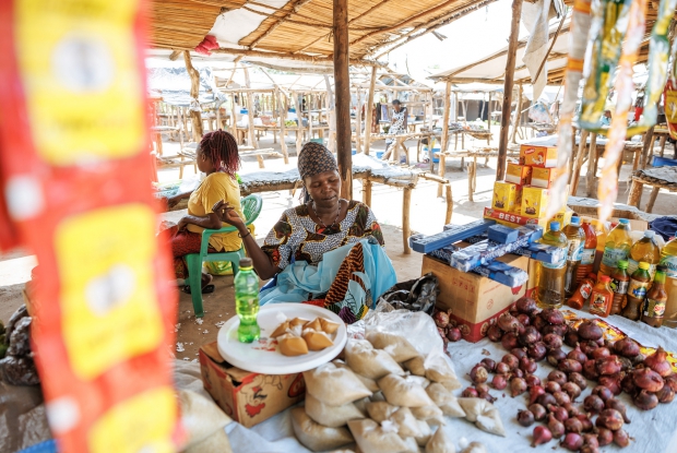 07/06/2024, Bidibidi Refugee settlement, Uganda. Rahima at her grocery stall in a local market. Upon her arrival at the camp, Rahima, a Single mother of five children relied on humanitarian relief assistance provided by the World Food Program and UN Agencies in the camp and it was hard for her to provide all the family basics. The DREAMS program provided Rahima with a seed grant, enabling her to start a business retailing mixed goods.  Whenever Rahima has a minute to spare, she makes/designs bedsheets for sale. Her current business value is worth about 1.6 million Uganda shillings. These enterprises enabled her to support her children by paying their school requirements, medical bills, clothing, and food.