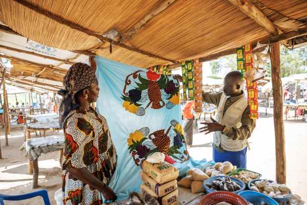 07/06/2024, Bidibidi Refugee settlement, Uganda. Rahima at her grocery stall in a local market. Upon her arrival at the camp, Rahima, a Single mother of five children relied on humanitarian relief assistance provided by the World Food Program and UN Agencies in the camp and it was hard for her to provide all the family basics. The DREAMS program provided Rahima with a seed grant, enabling her to start a business retailing mixed goods.  Whenever Rahima has a minute to spare, she makes/designs bedsheets for sale. Her current business value is worth about 1.6 million Uganda shillings. These enterprises enabled her to support her children by paying their school requirements, medical bills, clothing, and food.