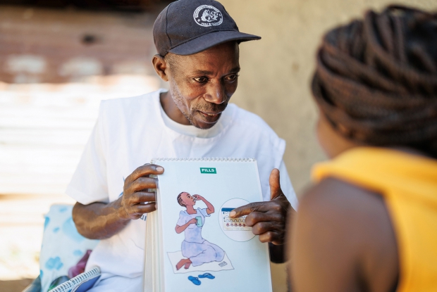 24-year-old Sandra intently listens to family planning advice from Kiriibwa Ronald, the Community Health Worker in her community. Ronald conducts daily home visits to his community to implement various programs that focus on maternal and child health. Community Health Workers like him also advise women on the family planning options to help them make informed decisions and even provide short-term methods like pills and condoms within their community, making them more accessible.
