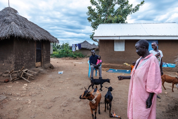 October 4th 2022- Bidi bidi refugee settlement, Uganda. Festo James with his family membersat their home in Bidibidi refugee settlement. Festo age 30 left South Sudan on foot in 2016, making the long and tedious walk to seek refuge in Uganda. He now lives in Bidi Bidi refugee settlement with his family and is the Vice Chairperson of Ala-Zabu savings group. &ldquo;If peace ever prevails in South Sudan, I would love to return to my country but for now I would like to expand my business"