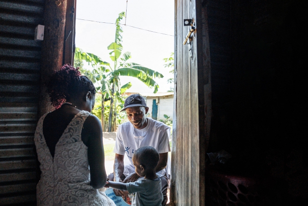 Nampijja, a mother and resident of Tubi-Kasekulo, Kalangala District, interacts with Kiiribwa Ronald, the area Community Health Worker who volunteers with Living Goods. These health workers help close the medical care gap among Lake side fishing villages on Lake Victoria through health education and home visits and treatment of malaria, diarrhoea and flu in children aged five and below.