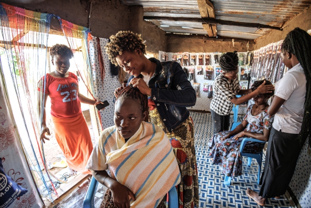 October 2022, MinAllah working at her salon in Bidibidi refugee settlement, Yume district, Uganda. 24-year-old  MinAllah arrived in Bidibidi refugee settlement in June 2016, and before joining DREAMS, she was involved in small-scale retail business and agriculture for home consumption but her heart was with the salon business. The DREAMS program provided Viola with a seed grant, enabling her to start a salon business valued at UGX 7,000,000. This new venture brought significant changes to her life and her family&rsquo;s well-being. With the profits from her salon, Viola now pays for her four siblings' education, covering all necessary school supplies. As an entrepreneur, Viola has created employment opportunities within her community, hiring two people and paying them UGX 15,000 daily. She also purchased two goats and 19 ducks, which she hopes will reproduce and provide additional resources.
