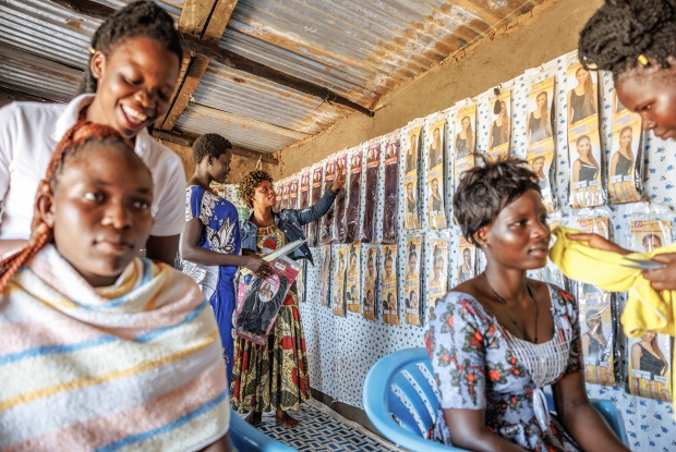 October 2022, MinAllah working at her salon in Bidibidi refugee settlement, Yume district, Uganda. 24-year-old  MinAllah arrived in Bidibidi refugee settlement in June 2016, and before joining DREAMS, she was involved in small-scale retail business and agriculture for home consumption but her heart was with the salon business. The DREAMS program provided Viola with a seed grant, enabling her to start a salon business valued at UGX 7,000,000. This new venture brought significant changes to her life and her family&rsquo;s well-being. With the profits from her salon, Viola now pays for her four siblings' education, covering all necessary school supplies. As an entrepreneur, Viola has created employment opportunities within her community, hiring two people and paying them UGX 15,000 daily. She also purchased two goats and 19 ducks, which she hopes will reproduce and provide additional resources.