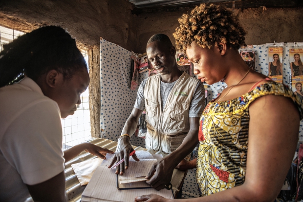Yada Mansuru, a field associate with Village Enterprise in Yumbe district interacts with Viola and her business partner, Dina Aba at their salon business. Under the DREAMS program, the business group received financial support with a seed grant to start a salon business valued at UGX 7,000,000. For Viola, this new venture brought significant changes to her life and her family&rsquo;s well-being. With the profits from the salon, Viola now pays for her four siblings' education, covering all necessary school supplies.