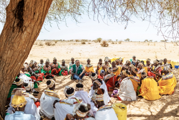 14/03/2025 Korr, Marsabit county - Kenya. Three Village savings groups, totaling up to 75 members, meet under a tree to share information and learn from a business mentor. These members were able to save Ksh 800,000. These saving groups have a common project of retailing livestock and operating butcheries. They also share market intelligence on trends, thus making more profit than others. Recently, the group has conducted fundraising for themselves through local leaders, raising Ksh3.5 million, and they hope to create a wider network of savings and credit.