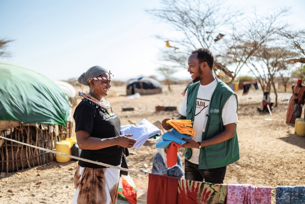 14/03/2025 - Korr, Laisamis Sub-County in the Marsabit county of Kenya, - 51-year-old Fatuma interacts with her business mentor, Mohammed. Fatuma enrolled in Kuza Jamii in June 2023, and she underwent training on business skills, where she chose to sell clothes that she sells at home and hawks around the town. She received a Ksh.30,000 grant from Village Enterprise in July 2024 and invested it all in the business. Fatuma sourced her clothes from Nairobi and sold them at Ksh.34000 per month, generating a monthly profit of Ksh.4000 on average. She has set up a bakery in a shared community space. Her business mentor, Mohammed, visits now and then to guide her on aspects of operating the business, from administrative logistics to navigating group dynamics. In January 2025, Fatuma saved enough to buy four sheep for herself.