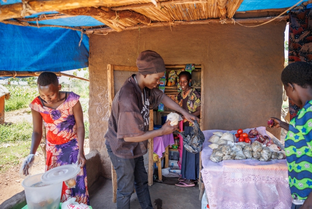 October 6th 2022- Yumbe district- Uganda. Village 1A, zone 4 Bidi bidi refugee settlement. - Saidu Business Group members making sales at their shop. This business was set up by three refugee women from Sudan. The business group deals in general merchandise, therefore extending basic home-use products to the community and putting some money in their pockets. Under the DREAMS Program, Village Enterprise supported the business group with UGX 432,000 under phase 1, and if the business grows, the group receives additional financial support.